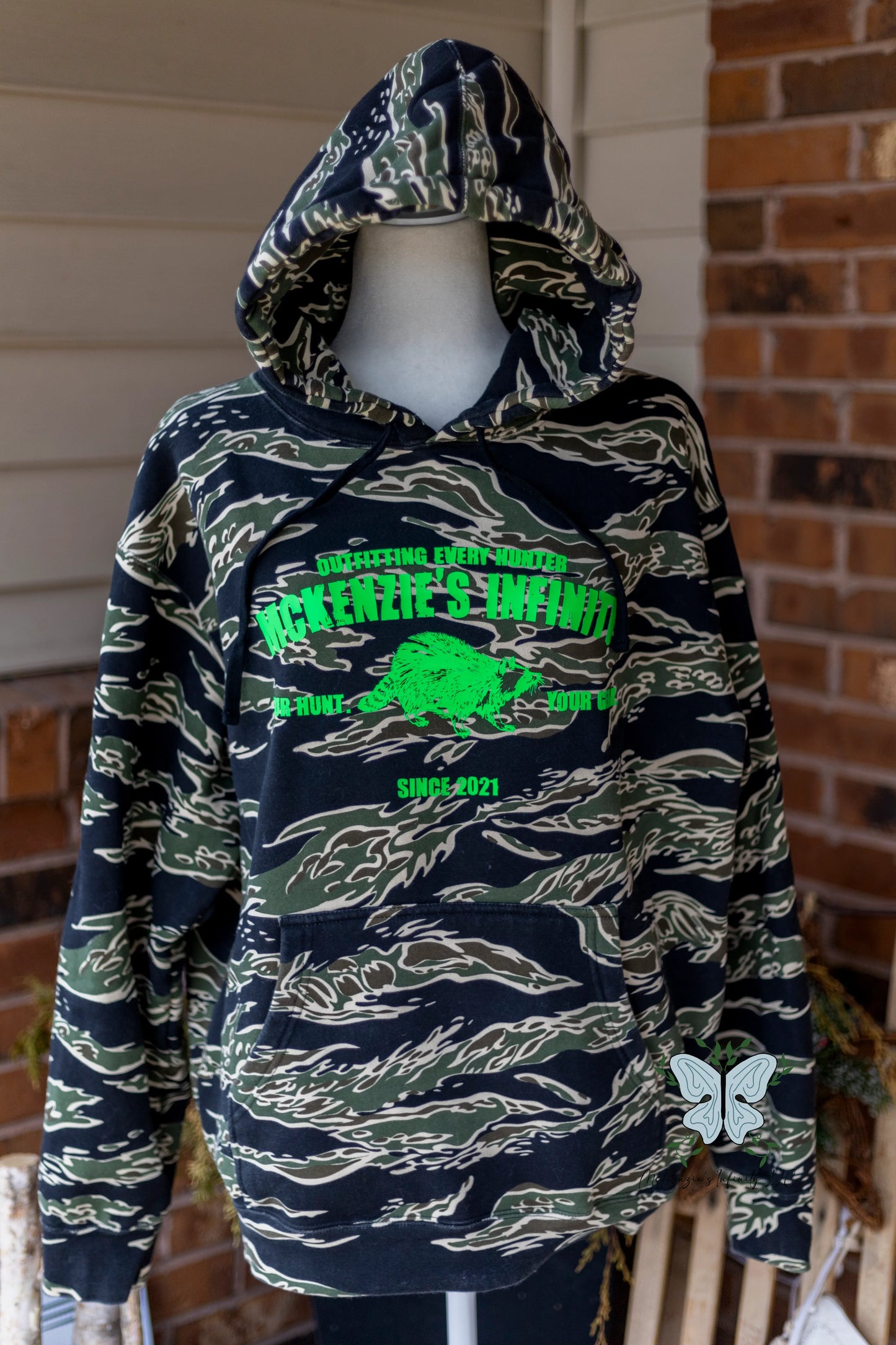 MI Outfitters Since 2021 - Raccoon Edition - Tiger Camo Heavyweight Hooded Sweatshirt ©️ - McKenzie's Infinity